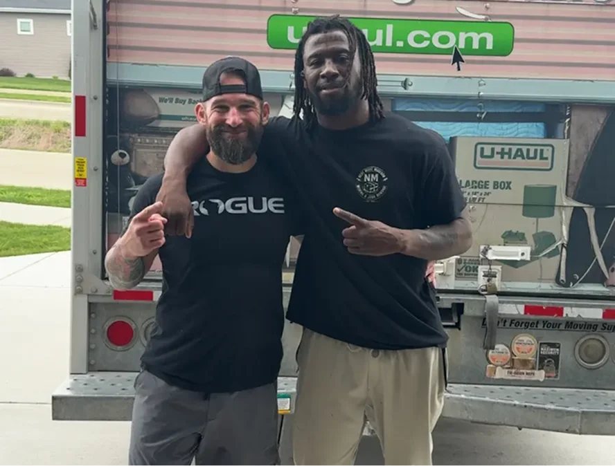 Two Next Move Madison team members with a friendly dog in a customer's home